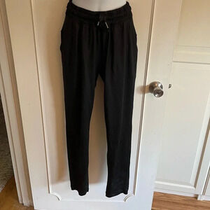 Lululemon black joggers with drawstring elastic waist band, and hemline.  Size 4